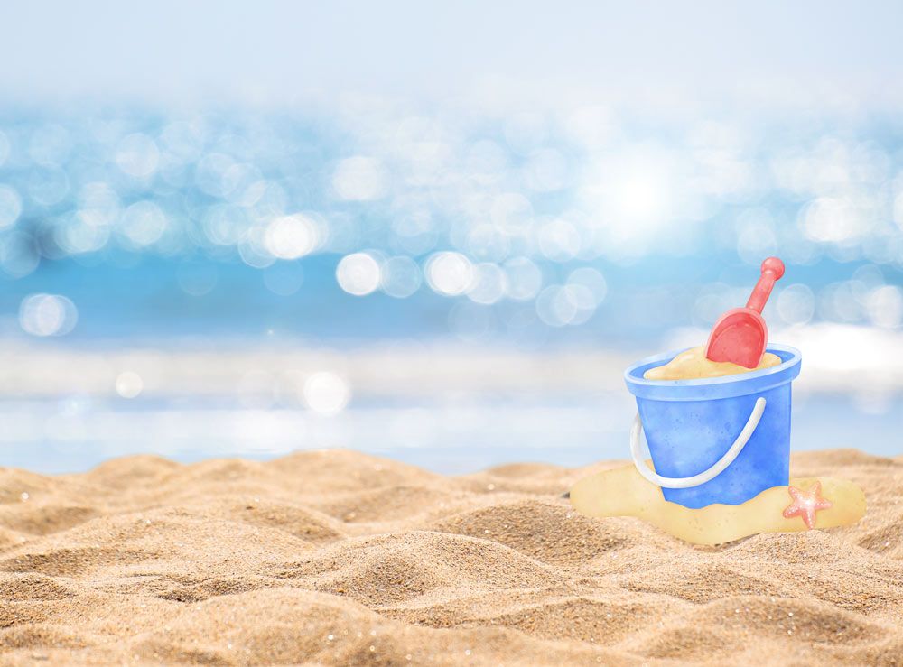 Sandy beach with a kid's bucket and shovel